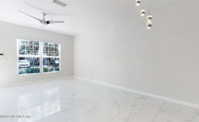 an empty room with windows and entrance