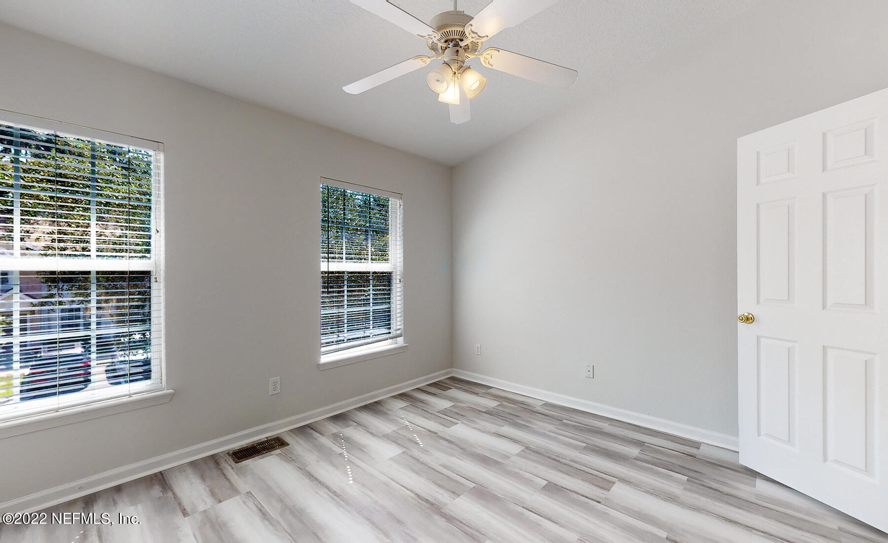 3526 Twisted Tree Lane Jacksonville, FL 32216 - Photo 21 of 33 a view of an empty room with a window and wooden floor