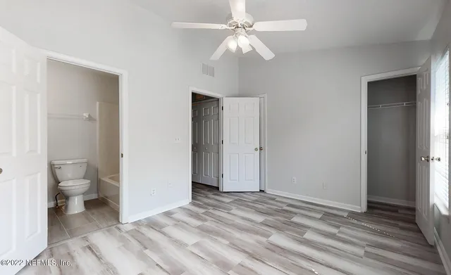 a view of a patio with table and chairs potted plants with large tree