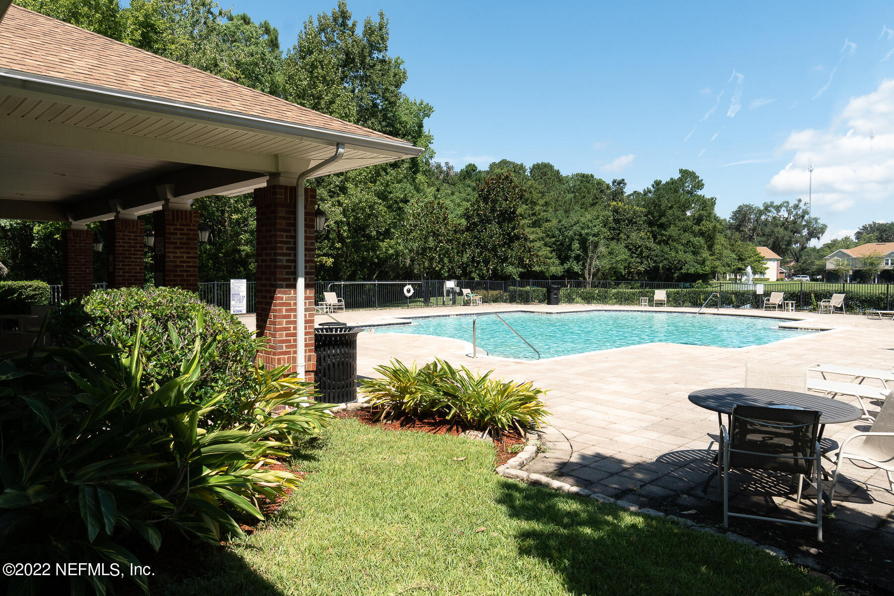 3526 Twisted Tree Lane Jacksonville, FL 32216 - Photo 24 of 33 a view of a patio with table and chairs potted plants with large tree