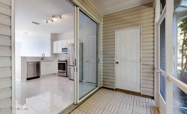 a kitchen with white cabinets and white appliances