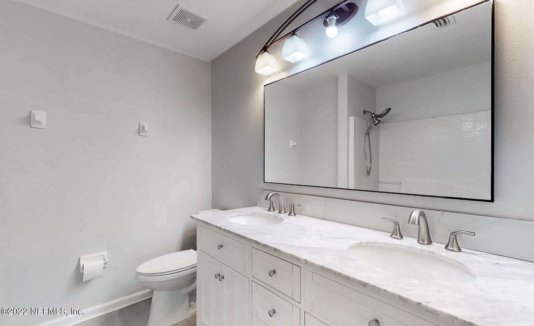 3526 Twisted Tree Lane Jacksonville, FL 32216 - Photo 5 of 33 a bathroom with a granite countertop sink mirror vanity and toilet