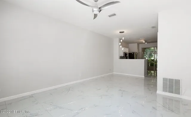 a view of a kitchen with furniture and a ceiling fan