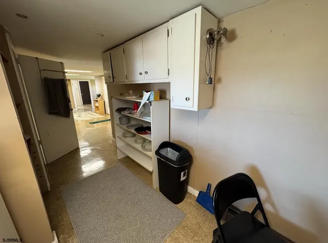 a kitchen with a refrigerator and a stove top oven