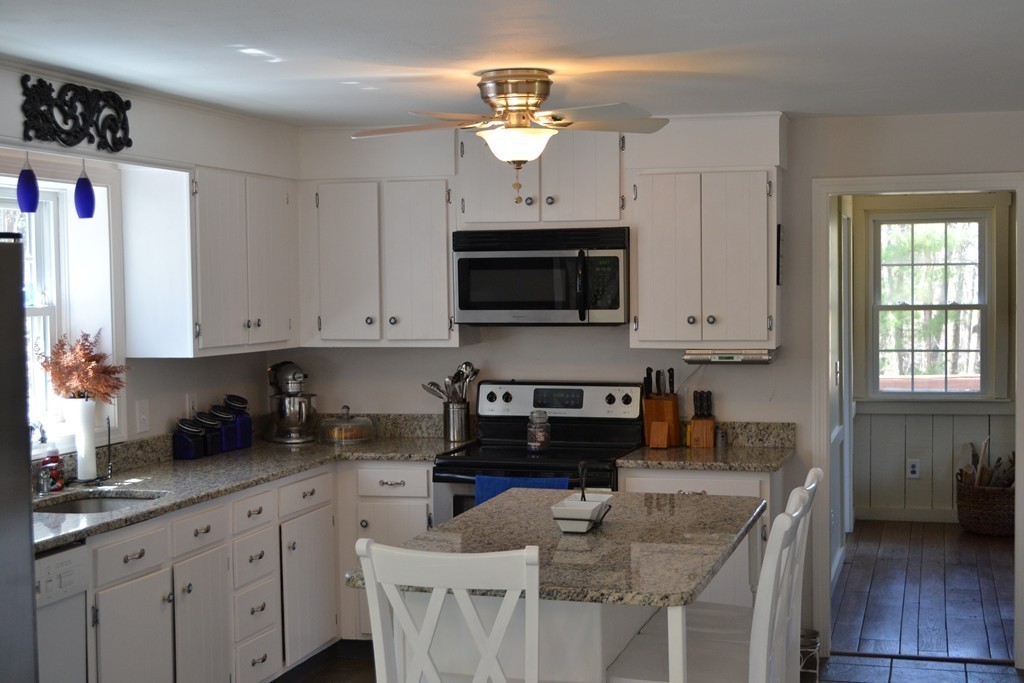 56 Dodge Road Sutton, MA 01590 - Photo 8 of 29 a kitchen with stainless steel appliances granite countertop a sink a microwave a refrigerator and cabinets