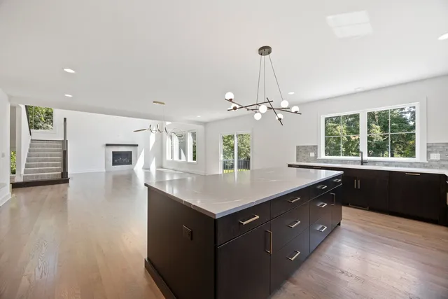 a kitchen with a counter space a sink appliances and a window