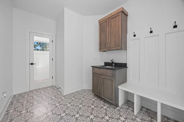a view of kitchen with granite countertop cabinets and sink