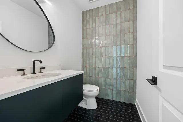 a bathroom with a sink a toilet and a mirror