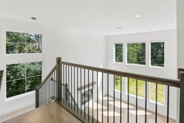 a view of a porch with wooden floor and iron fence