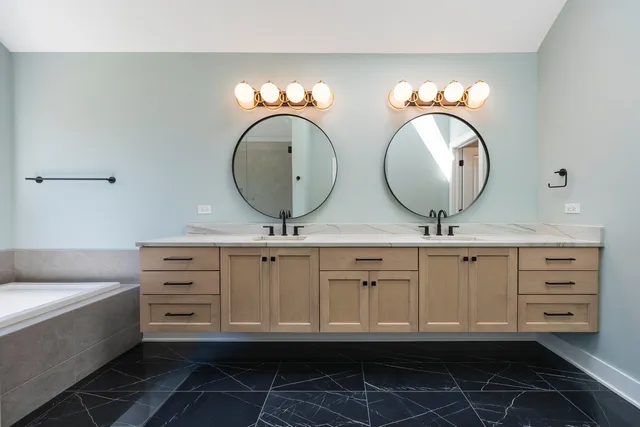 a bathroom with a double vanity sink mirror and toilet