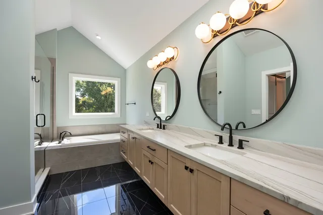 a bathroom with a double vanity sink and a mirror