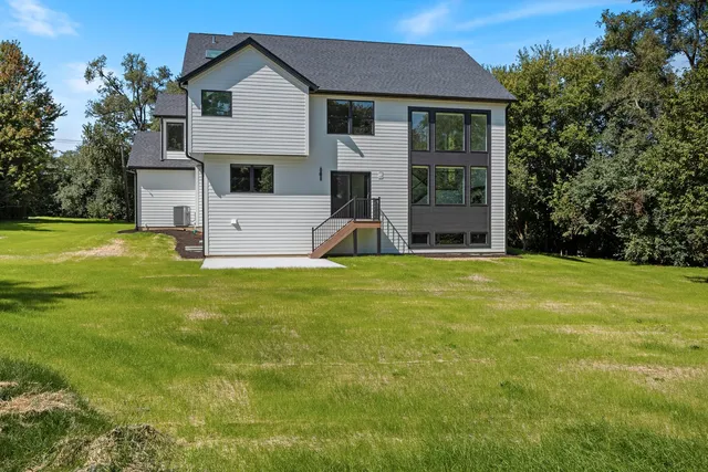 a view of a house with a yard and sitting area