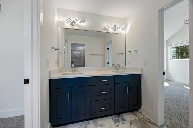 a bathroom with a double vanity sink and a mirror
