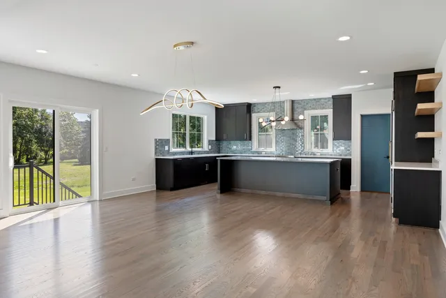 a large kitchen with a large counter top and stainless steel appliances