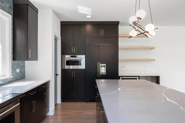 a kitchen with a refrigerator and cabinets