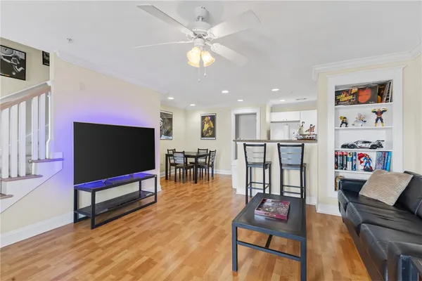 a living room with furniture and a ceiling fan