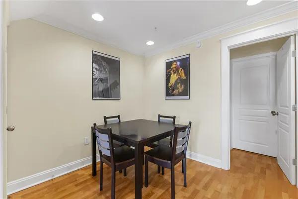 a kitchen with granite countertop a sink stainless steel appliances and white cabinets