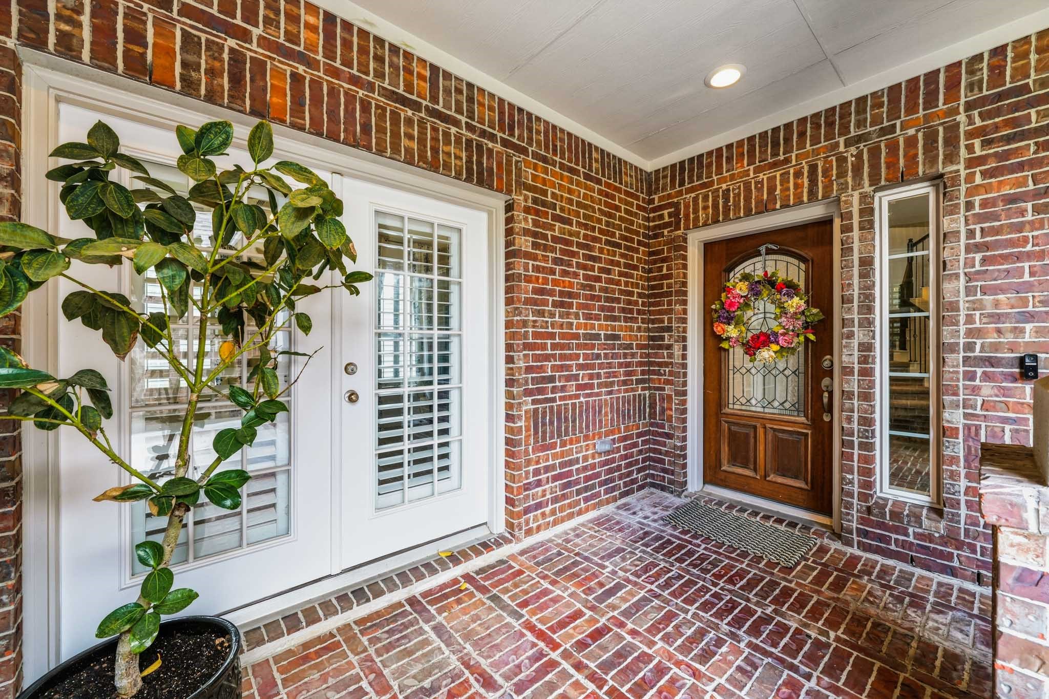 17610 Strackfield Lane Tomball, TX 77377 - Photo 3 of 50 A welcoming covered front porch creates an inviting first impression, with two entrances to the home. One is for the "Next Gen" suite for multigenerational living while the wood and glass entry door leads you to the main home.