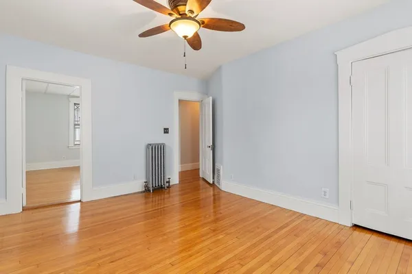 wooden floor in an empty room with a window