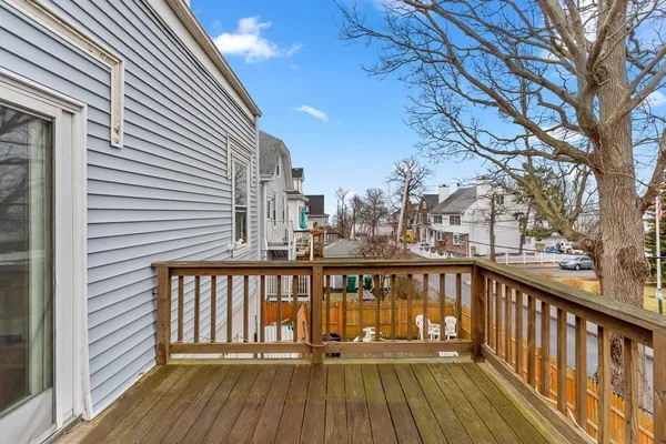 a view of balcony with wooden floor and fence