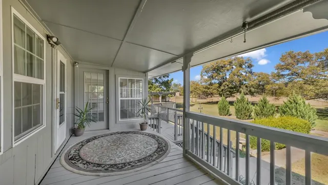 a living room with furniture a fireplace and a large window