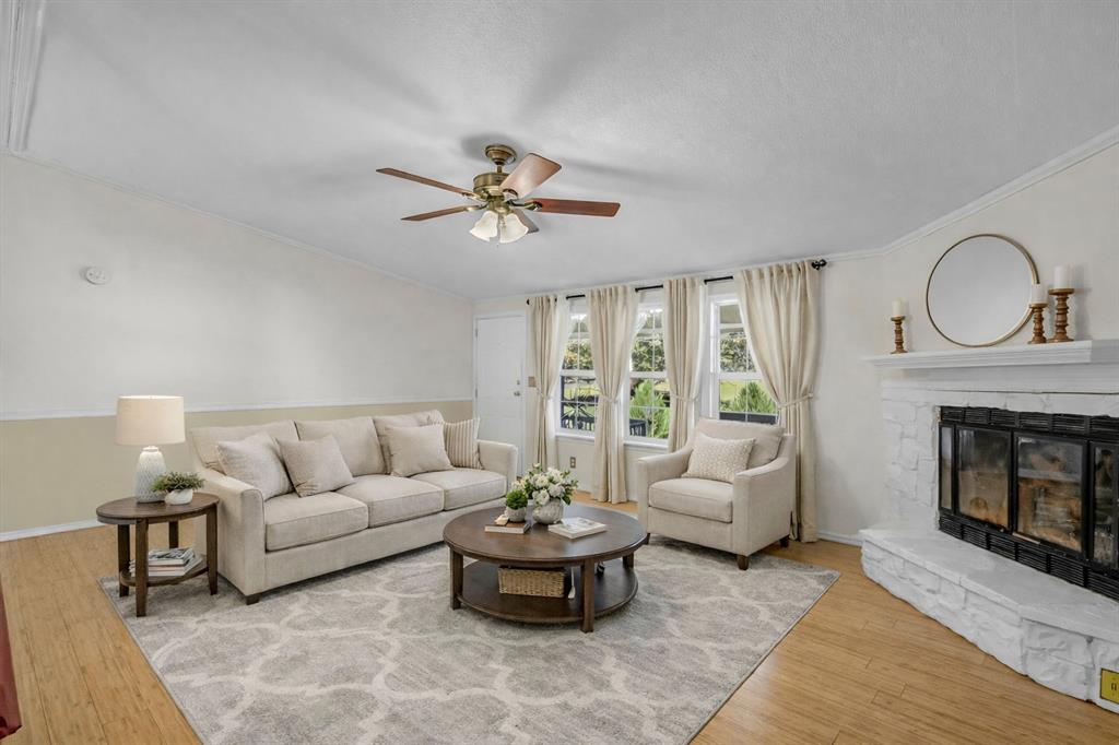 1240 Riverview Road Millsap, TX 76066 - Photo 15 of 36 a living room with furniture a fireplace and a large window