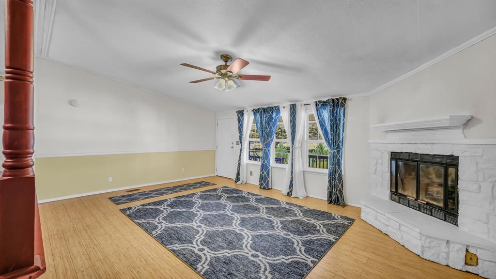 1240 Riverview Road Millsap, TX 76066 - Photo 16 of 36 a spacious bedroom with a bed and a fireplace