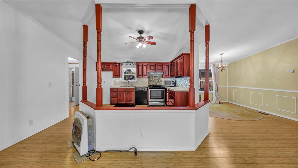 1240 Riverview Road Millsap, TX 76066 - Photo 19 of 36 a living room with kitchen island granite countertop furniture and a flat screen tv