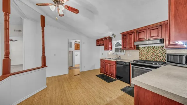 a dining room with furniture wooden floor a rug and a chandelier