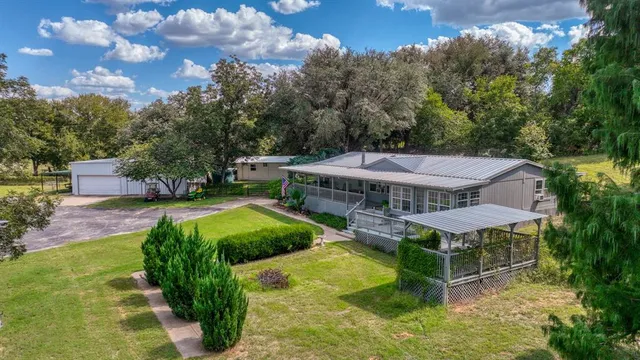 a view of a house with backyard porch and sitting area