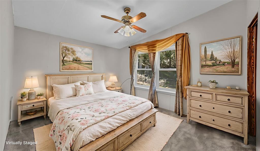 1240 Riverview Road Millsap, TX 76066 - Photo 31 of 36 a bedroom with a bed and a painting on the wall