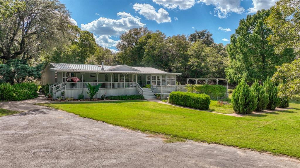 1240 Riverview Road Millsap, TX 76066 - Photo 4 of 36 a view of a house with a big yard