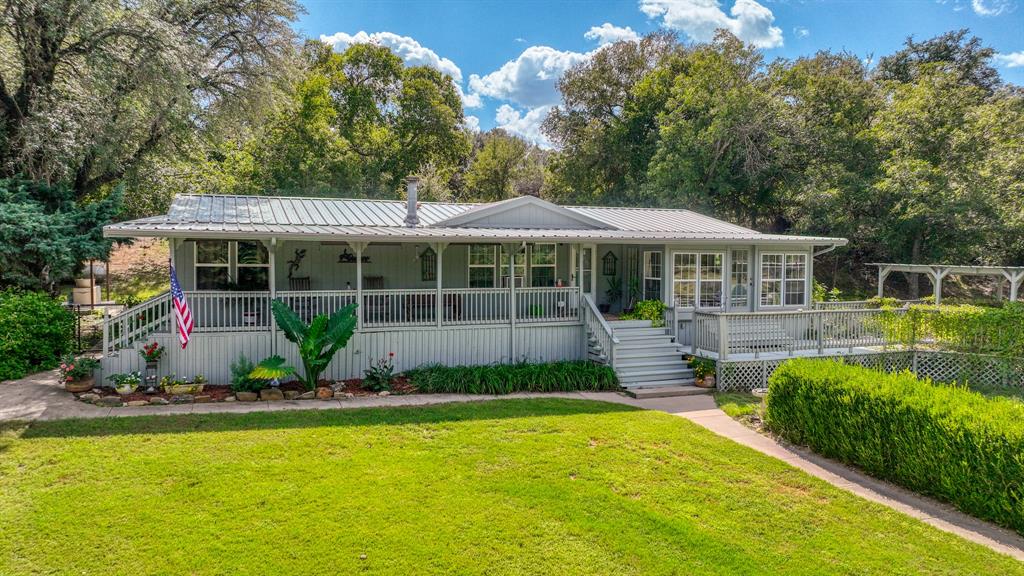 1240 Riverview Road Millsap, TX 76066 - Photo 5 of 36 a front view of a house with swimming pool and porch with furniture