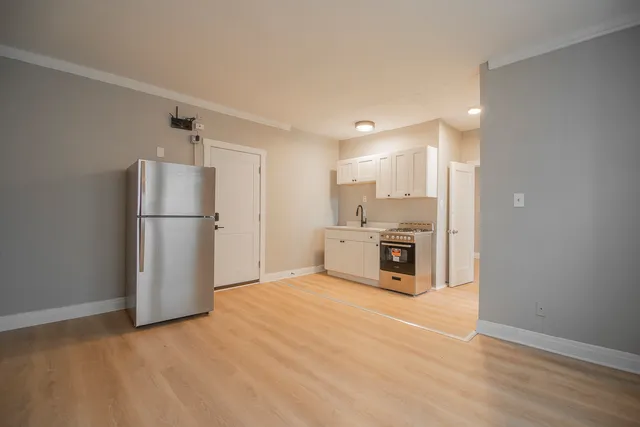 a kitchen with stainless steel appliances a refrigerator and a stove top oven