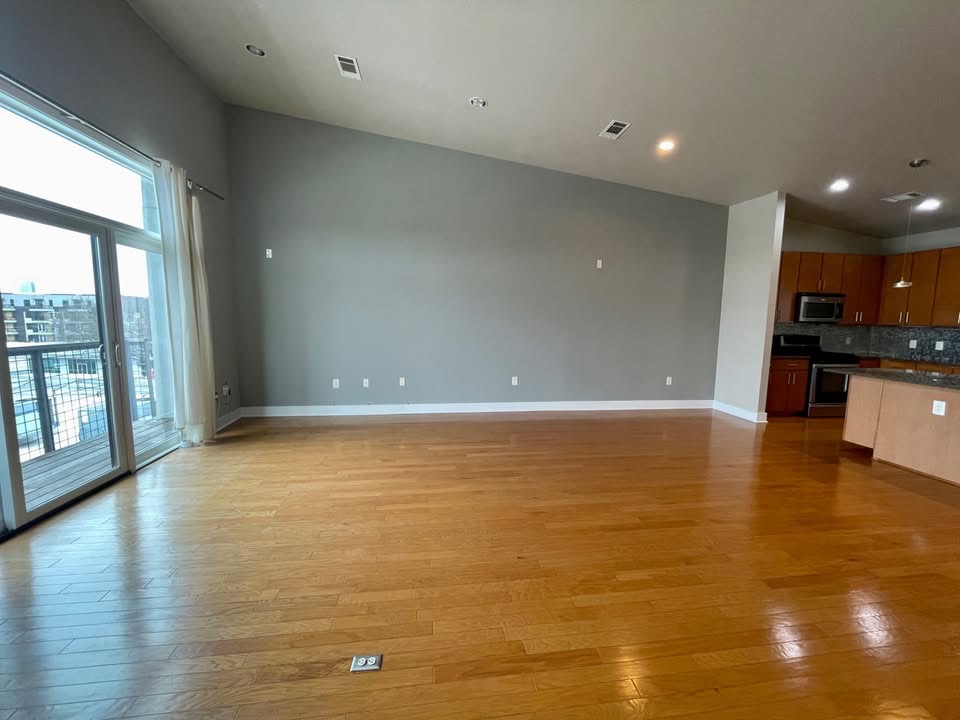 1702 South Lamar Boulevard, Unit 2 Austin, TX 78704 - Photo 11 of 25 Unfurnished living room with lofted ceiling, light wood-type flooring, and recessed lighting
