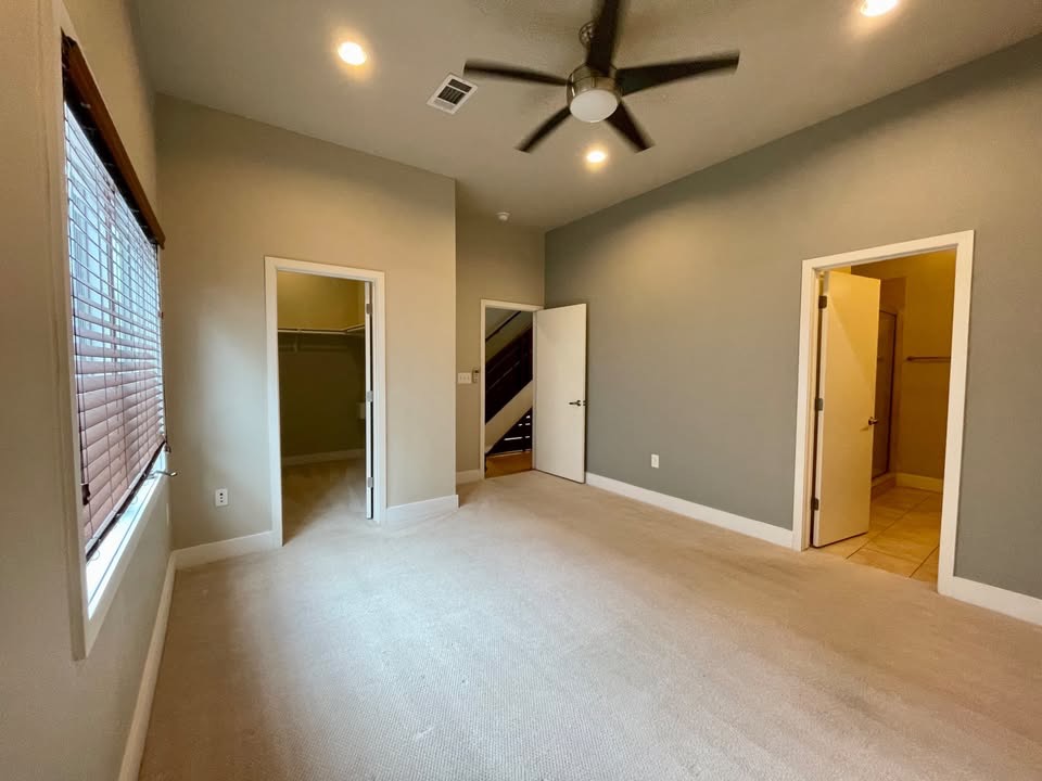1702 South Lamar Boulevard, Unit 2 Austin, TX 78704 - Photo 16 of 25 Unfurnished bedroom with a walk in closet, light carpet, ceiling fan, and recessed lighting