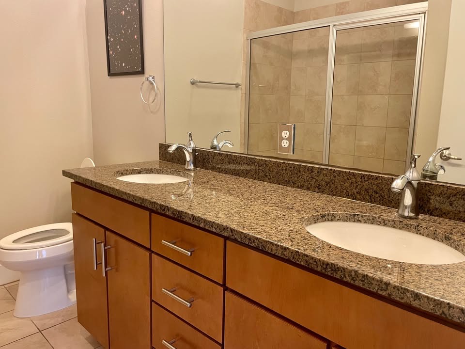 1702 South Lamar Boulevard, Unit 2 Austin, TX 78704 - Photo 18 of 25 Bathroom featuring double vanity, light tile patterned floors, and a stall shower