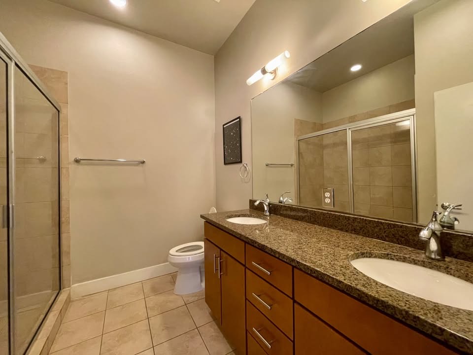 1702 South Lamar Boulevard, Unit 2 Austin, TX 78704 - Photo 19 of 25 Full bath with double vanity, light tile patterned floors, a stall shower, and recessed lighting