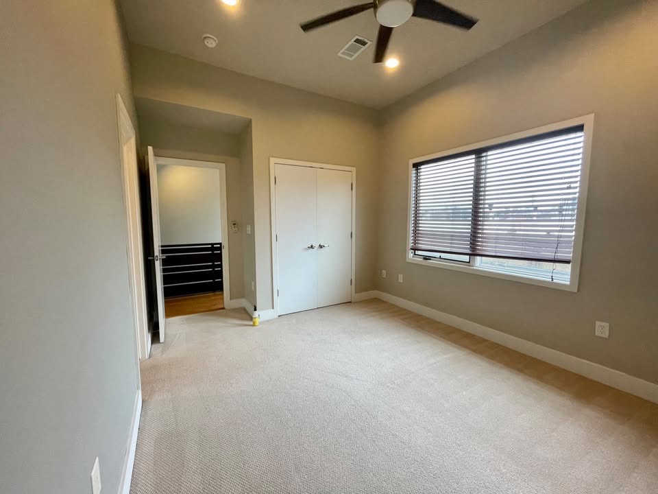 1702 South Lamar Boulevard, Unit 2 Austin, TX 78704 - Photo 23 of 25 Unfurnished bedroom featuring light colored carpet, ceiling fan, and a closet