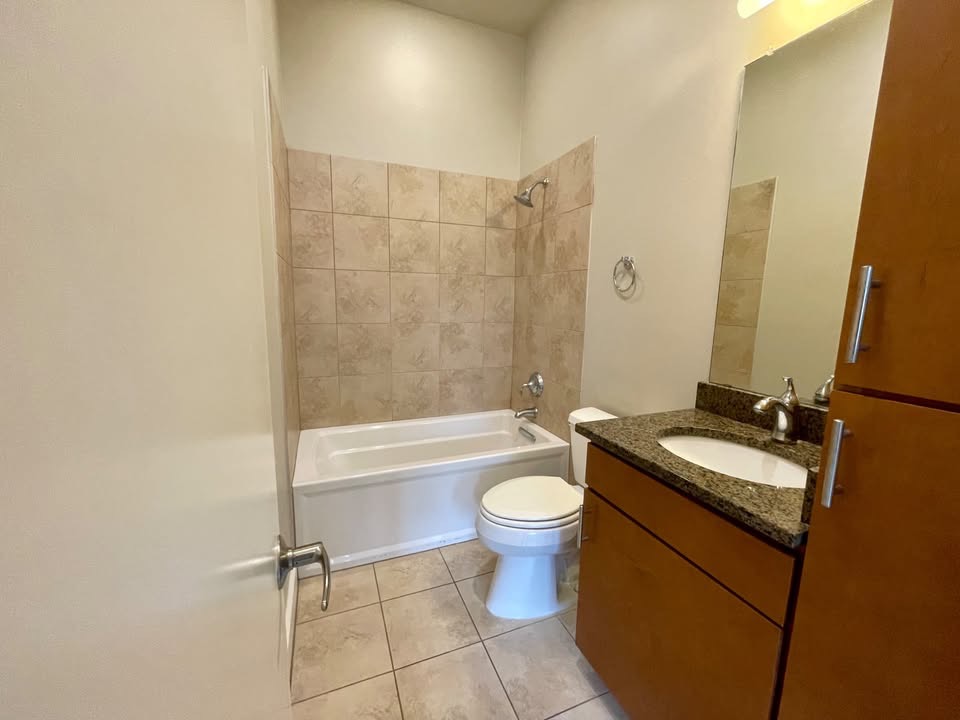 1702 South Lamar Boulevard, Unit 2 Austin, TX 78704 - Photo 24 of 25 Bathroom with vanity, shower / bathtub combination, and light tile patterned floors