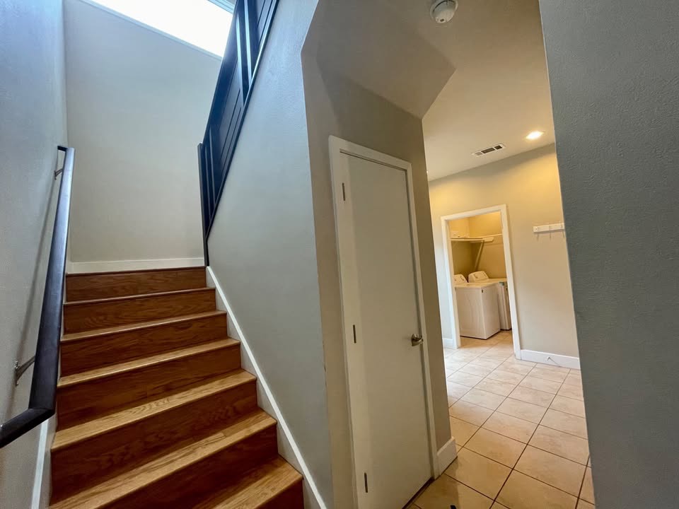 1702 South Lamar Boulevard, Unit 2 Austin, TX 78704 - Photo 25 of 25 Stairs featuring washer and clothes dryer, tile patterned floors, and recessed lighting