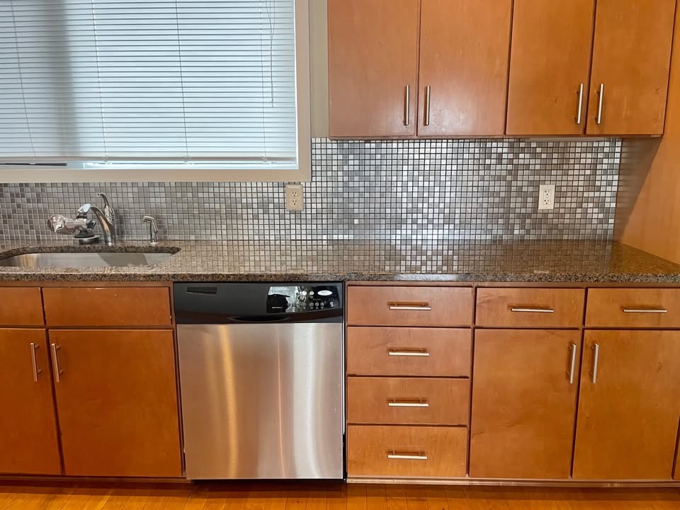 1702 South Lamar Boulevard, Unit 2 Austin, TX 78704 - Photo 3 of 25 Kitchen with stainless steel dishwasher, dark stone countertops, and decorative backsplash