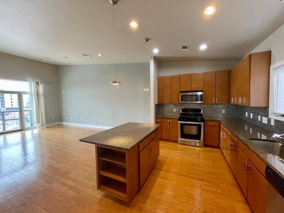 1702 South Lamar Boulevard, Unit 2 Austin, TX 78704 - Photo 9 of 25 Kitchen featuring plenty of natural light, open shelves, stainless steel appliances, hanging light fixtures, and recessed lighting