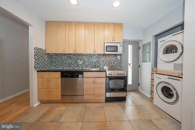 a kitchen with a stove a washer and dryer