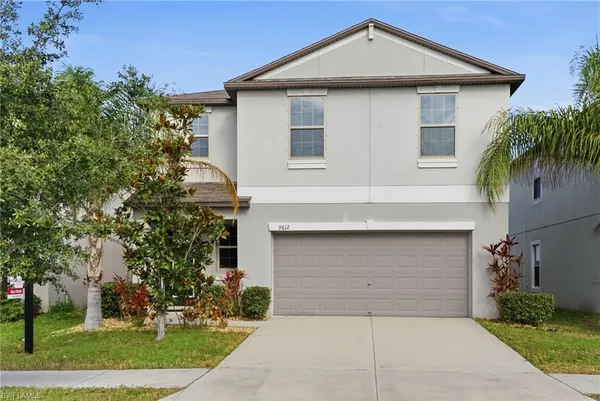a front view of a house with a yard and garage