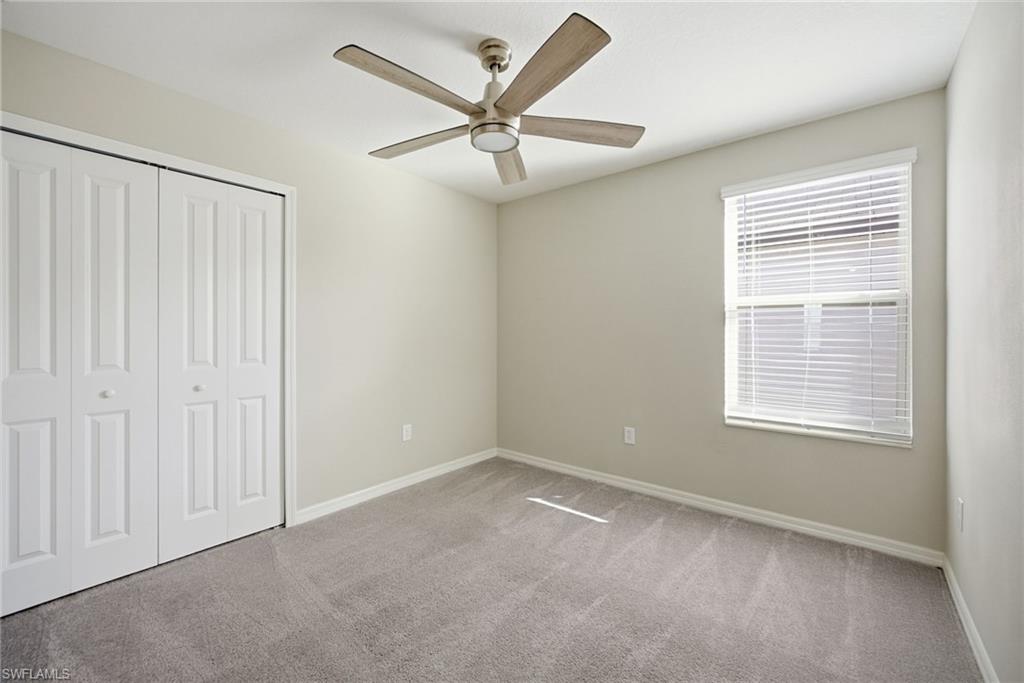 9612 Lemon Drop Loop Sun City Center, FL 33573 - Photo 9 of 33 an empty room with a window and a fan