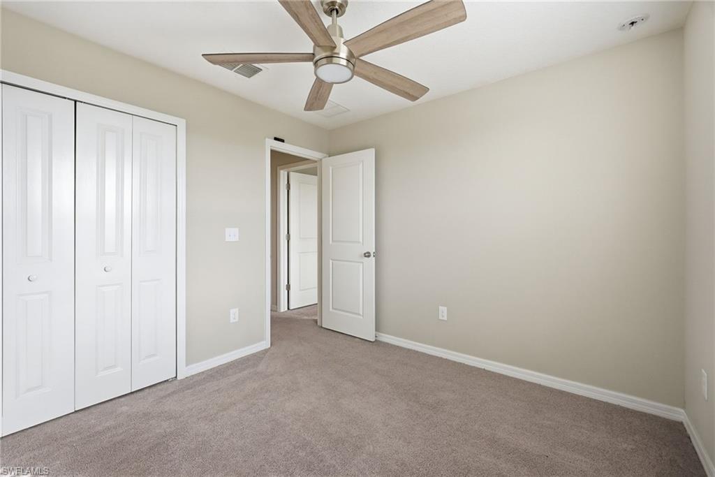 9612 Lemon Drop Loop Sun City Center, FL 33573 - Photo 16 of 33 an empty room with closet and fan