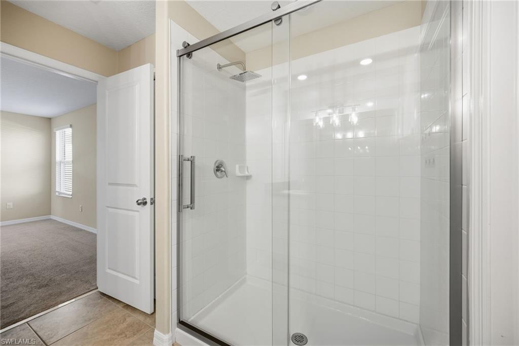 9612 Lemon Drop Loop Sun City Center, FL 33573 - Photo 18 of 33 a bathroom with a glass shower door