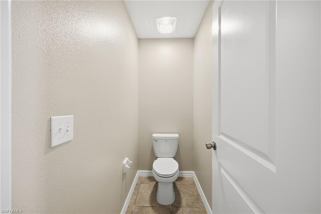 9612 Lemon Drop Loop Sun City Center, FL 33573 - Photo 25 of 33 a bathroom with a toilet and a shower