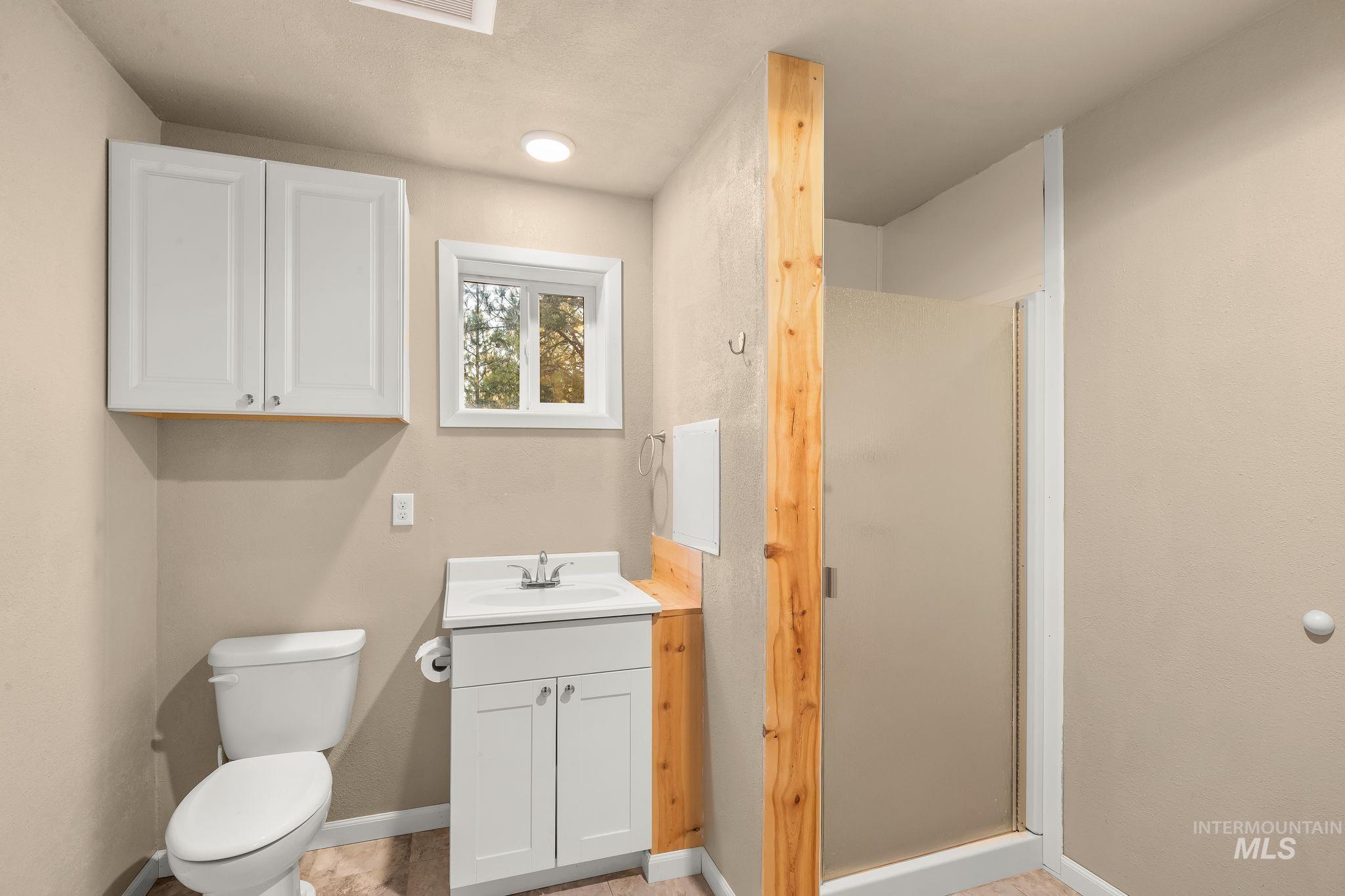 435 River Pointe Lane Lenore, ID 83541 - Photo 35 of 50 Spacious shop featuring exposed wood beam ceiling, concrete flooring, ample wall space, and multiple entry points